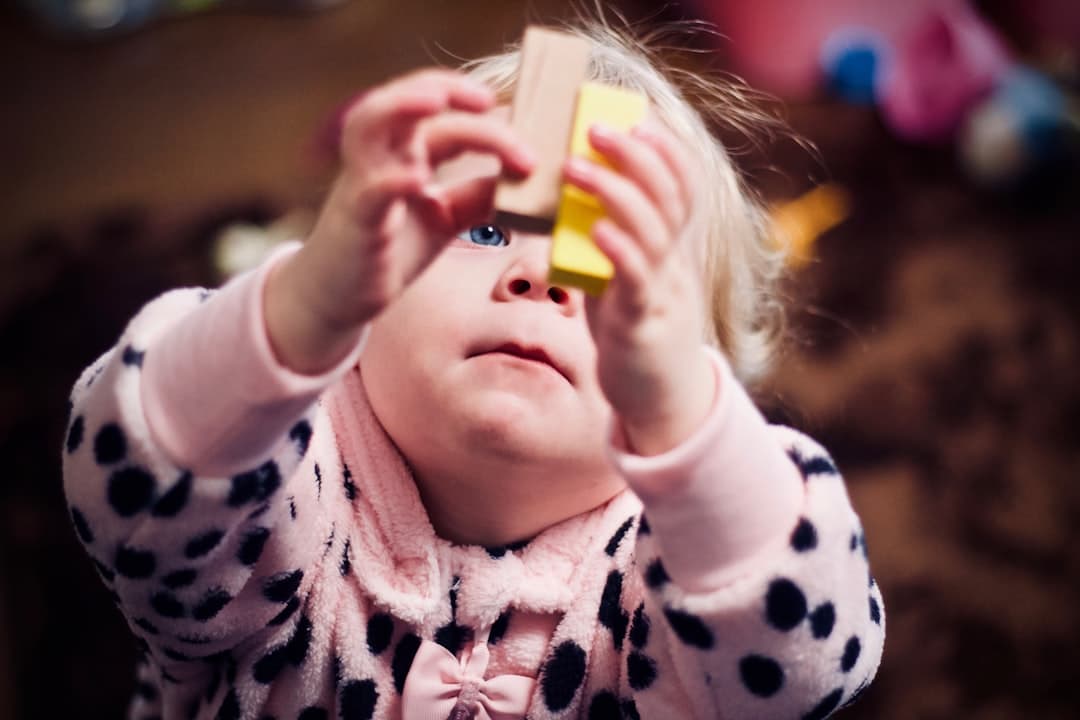 Child playing with wooden stacking toy